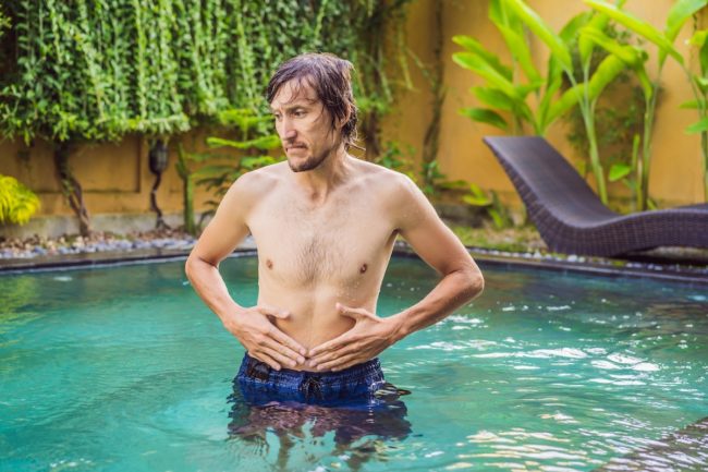 The man’s stomach hurts after the pool Swim after Eating